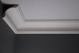 A close-up image of a white Victorian plaster coving on a ceiling, showcasing its intricate design and detail.